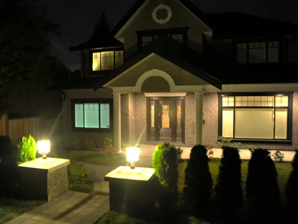 Evening elevation of the 14th Street residence with lit entry