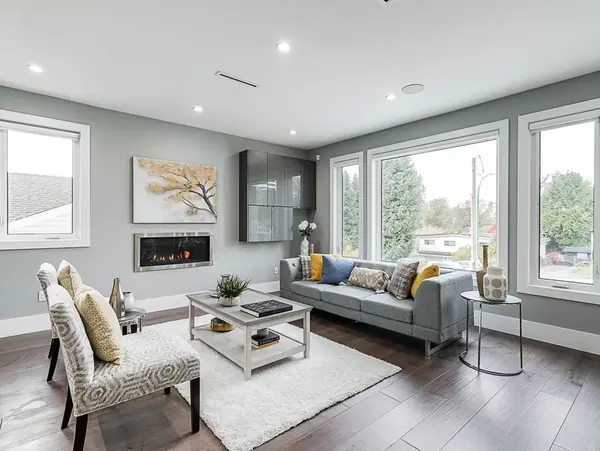 Living room with linear fireplace and large windows