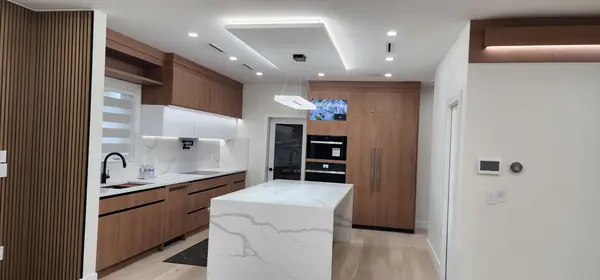 Walnut kitchen with waterfall island and integrated appliances