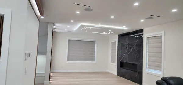 Open living area with linear fireplace before furnishing