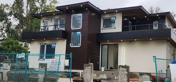 Framing and exterior sheathing in progress with scaffolding