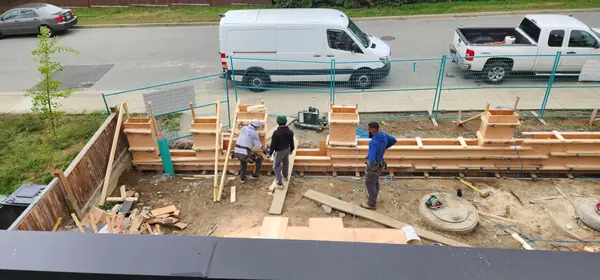 Foundation formwork and site crew at the start of construction