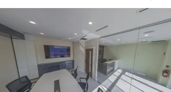 Boardroom interior with wall-mounted display and full-height glazing