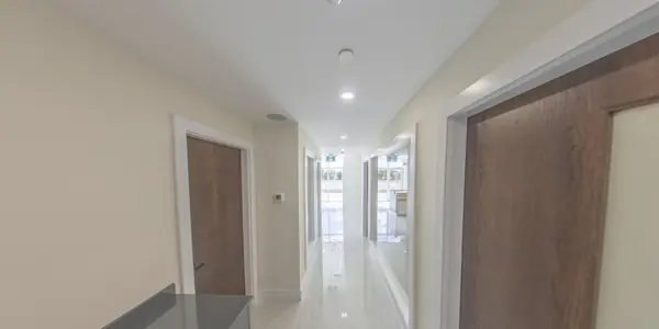 Corridor connecting the offices, finished in white with timber doors
