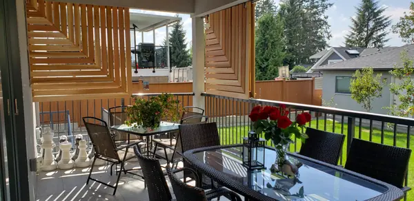 Covered deck with cedar privacy screen and outdoor dining