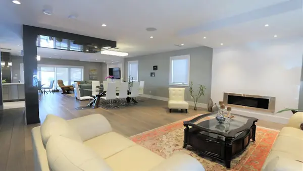 Open living and dining area with linear fireplace